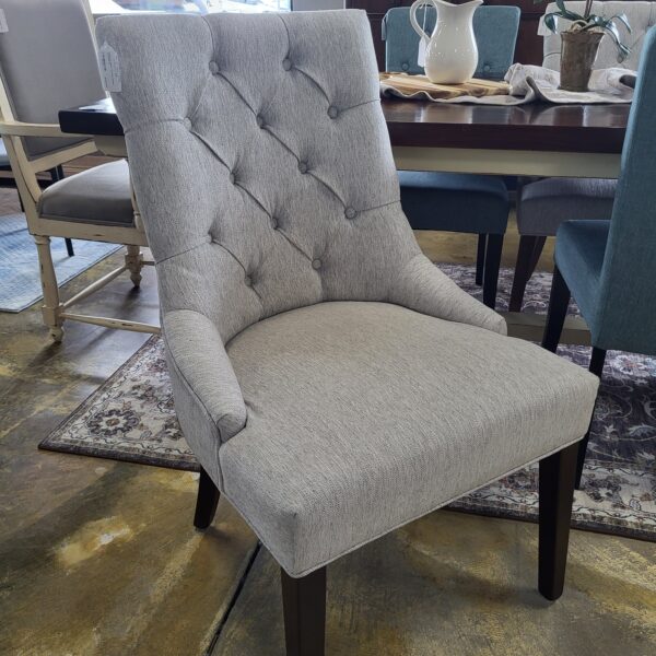 pair of grey tufted dining chairs