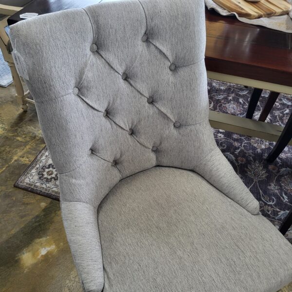 pair of grey tufted dining chairs